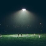 group of people playing soccer on soccer field