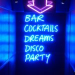 neon sign reading bar cocktails dreams disco party