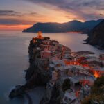 aerial view of village on mountain cliff during orange sunset