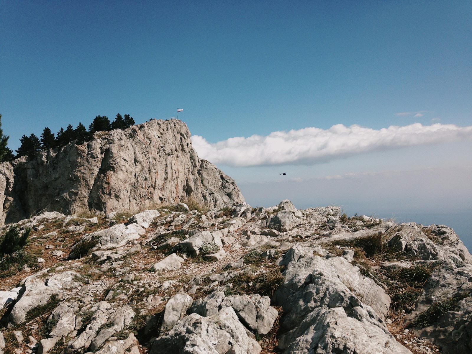 gray rocky mountain near body of water during daytime