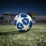 white blue soccer ball on green grass field during daytime